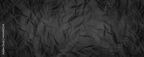 Rugged wrinkled crumpled dark black paper texture background