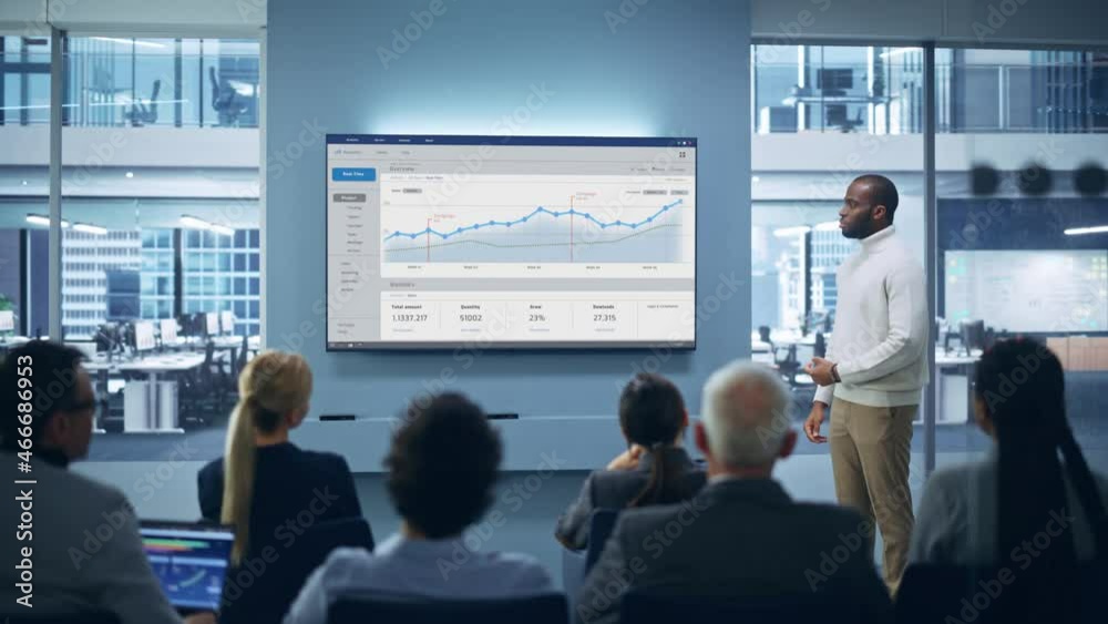 Modern Product Presentation Event: On-Stage Successful Black Businessman Speaker Presents e-Commerce Startup Big Data Statistics, Charts, Revenue Growth Infographics. Live Event. Press Conference