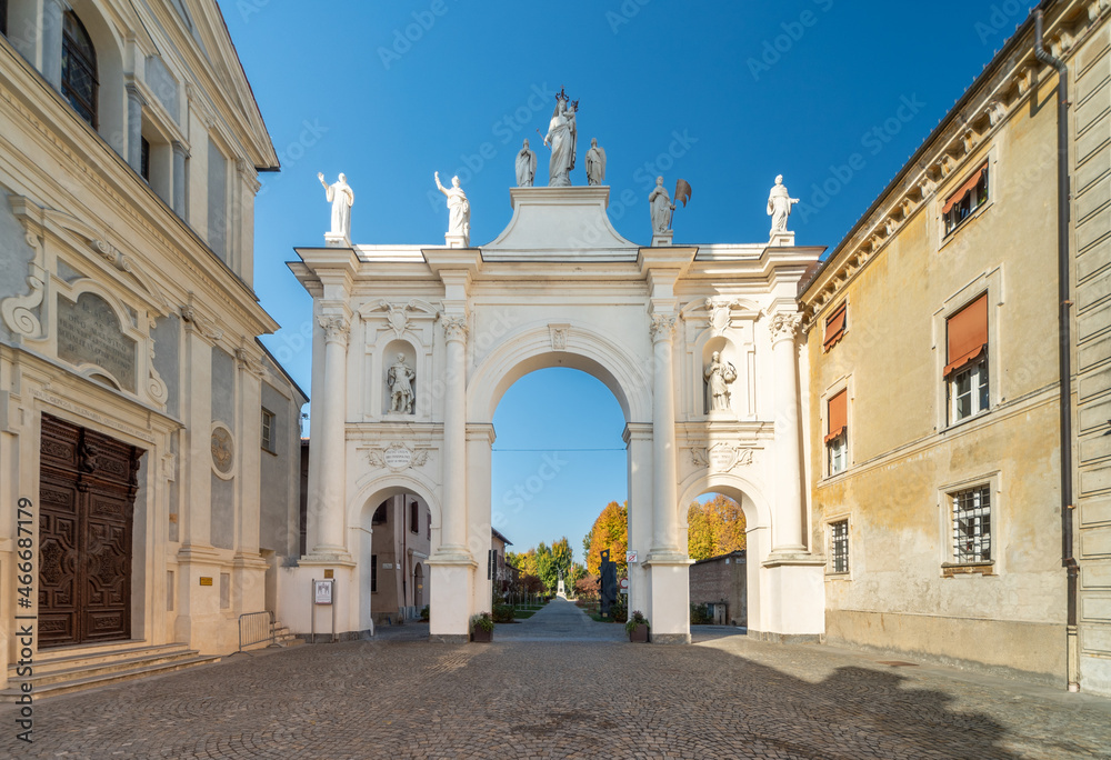 Cherasco, Cuneo, Italy - October 27, 2021: Arch of Belvedere, ex voto for escaped the plague and the church of Sant Agostino (17th century designed by Giovenale Boetto) in via Vittorio Emanuele II