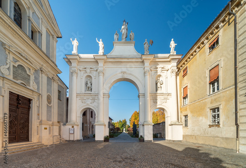 Cherasco, Cuneo, Italy - October 27, 2021: Arch of Belvedere, ex voto for escaped the plague and the church of Sant Agostino (17th century designed by Giovenale Boetto) in via Vittorio Emanuele II photo