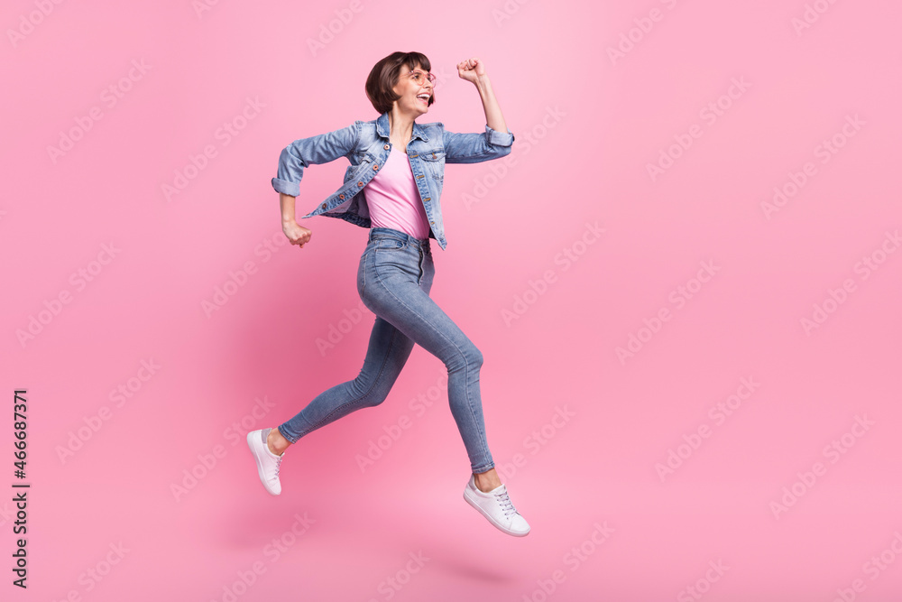Full length body size view of lovely cheerful girl jumping running motivation isolated over pink pastel color background