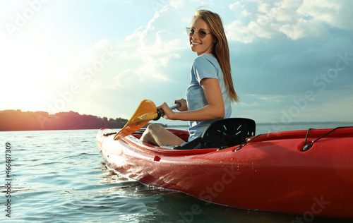 Happy woman kayaking on river. Summer activity