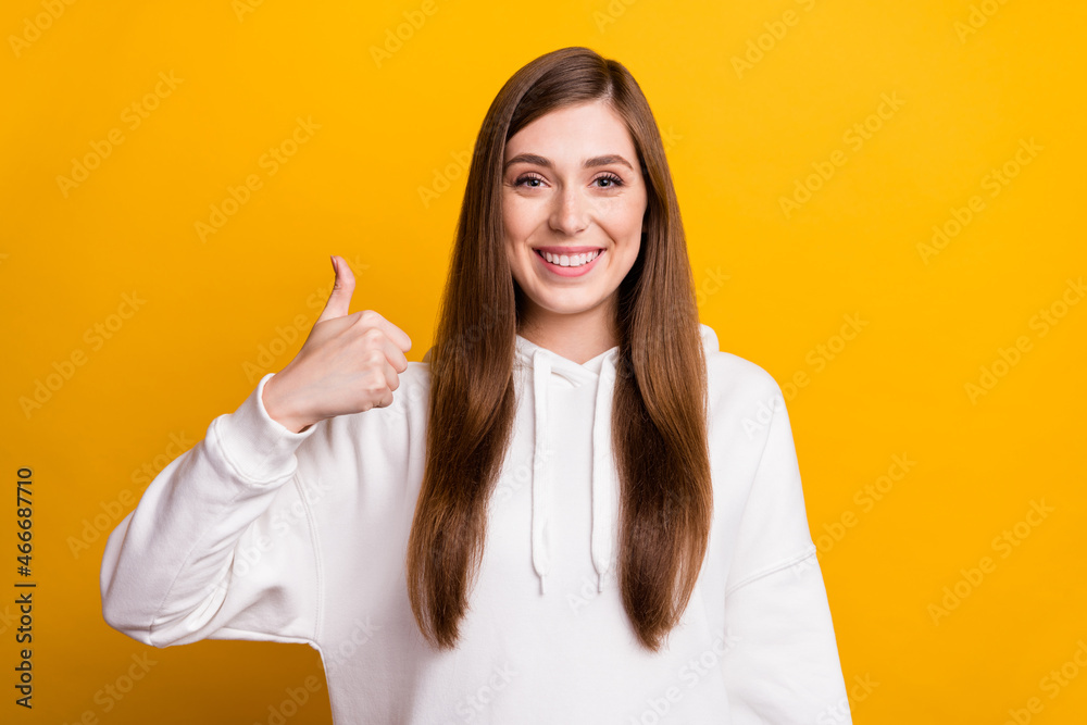 Photo of cheerful young happy positive lady make thumb up recommend isolated on yellow color background Photo of cheerful young happy positive lady make thumb up recommend isolated on yellow color background