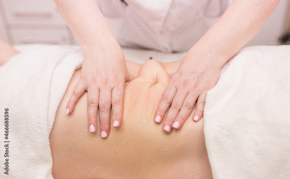 Massage on the problem areas of the body for weight loss and body correction. Master massage therapist makes anti-cellulite massage to a young girl. Spa treatments relaxing massage. chiropractor Massage on the problem areas of the body for weight loss and body correction. Master massage therapist makes anti-cellulite massage to a young girl. Spa treatments relaxing massage. chiropractor