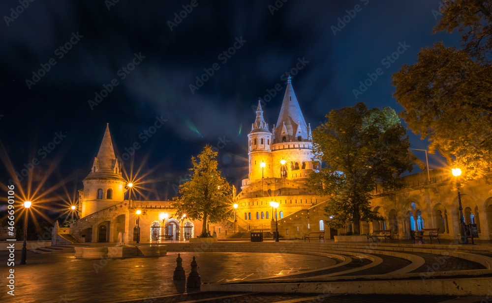 The Fisherman's Bastion in floodlight under the starry night sky in Hungary, Budapest