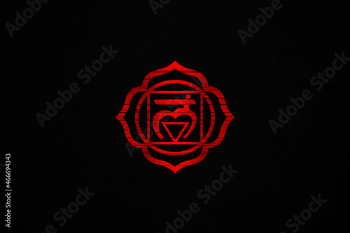Red Muladhara chakra sacred symbol on a black canvas photo