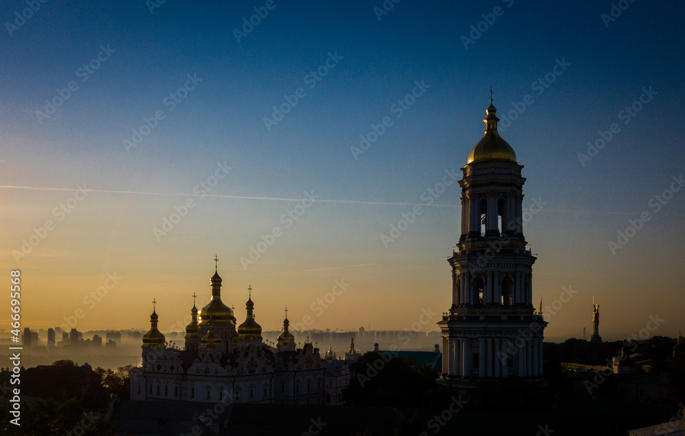 Fototapeta premium Beautiful aerial view of Pechersk Lavra in Kyiv at sunrise. A UNESCO world heritage site in Ukraine. View from drone. Space for text. 