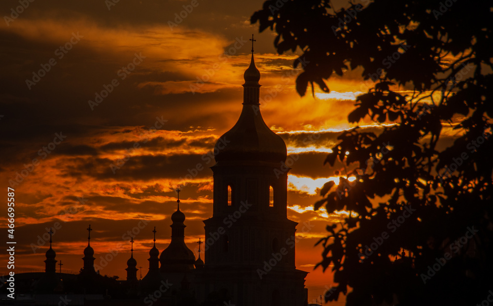 Silhouette of the orthodox church domes with bell tower in Kyiv the capital of Ukraine. Silhouette of the domes of St. Sophia Cathedral against the background of the sunset sky background.