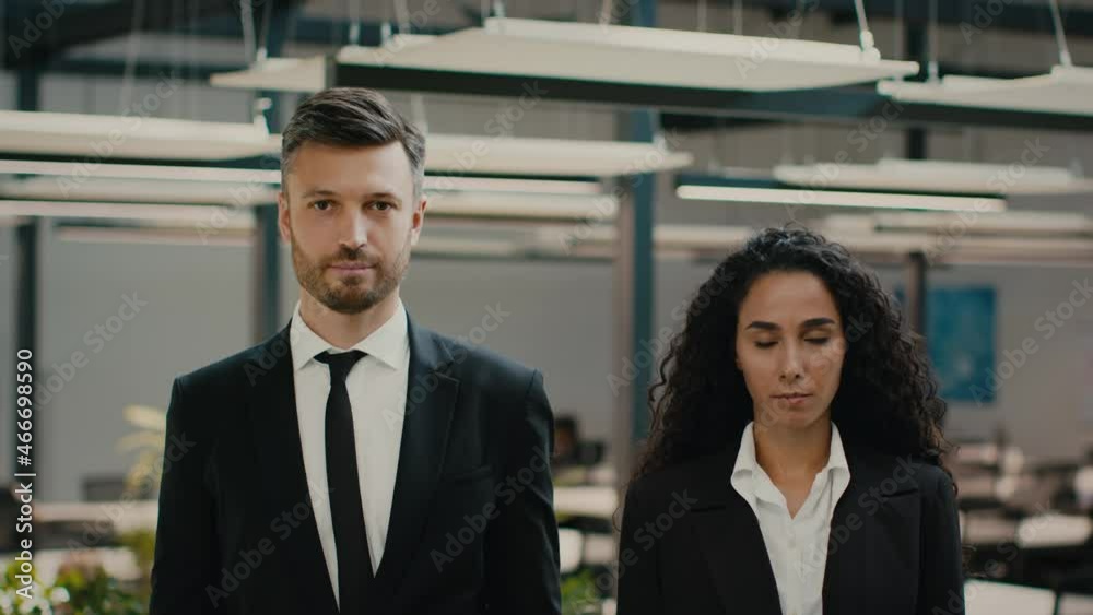 Male And Female Business Colleagues Posing Standing In Modern Office Male And Female Business Colleagues Posing Standing In Modern Office