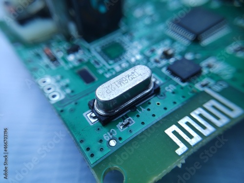 Close up image of crystal oscillator or electronic oscillator circuit. Electronic component.