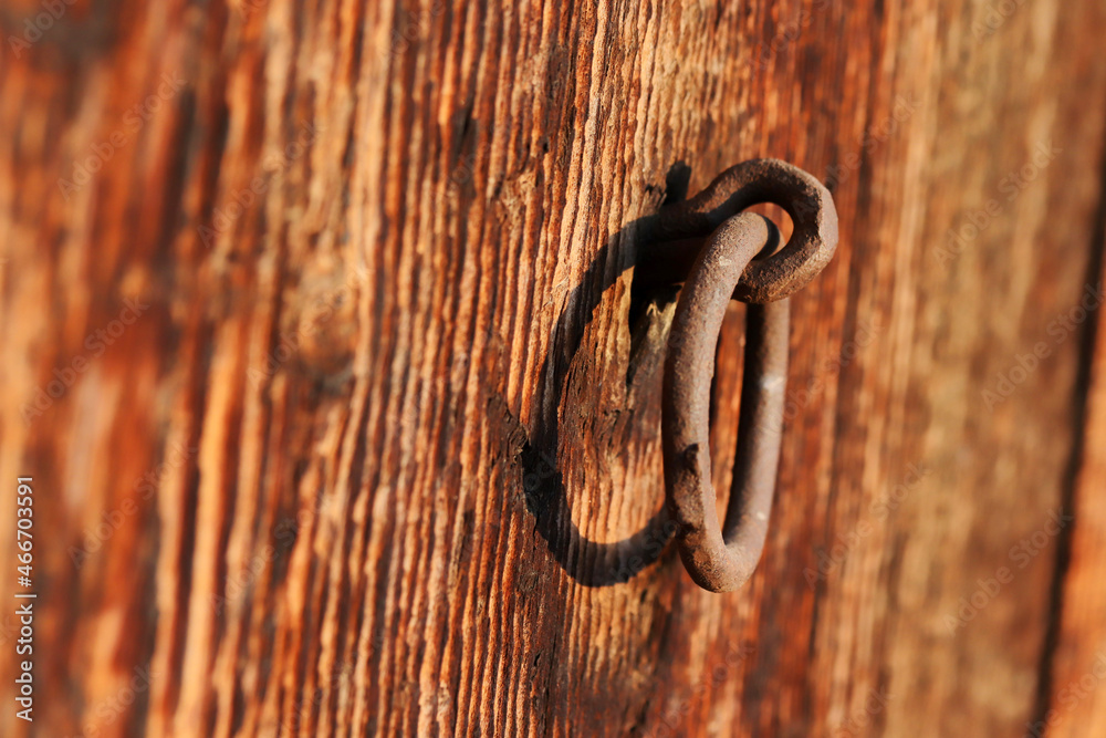 rusty iron doorknob on old wooden door rusty iron doorknob on old wooden door