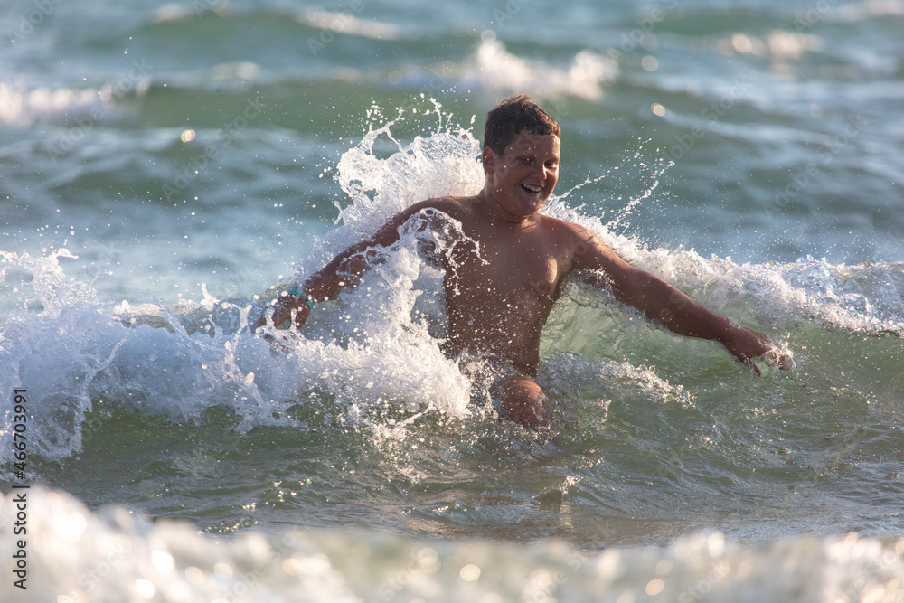 The boy swims in  sea.