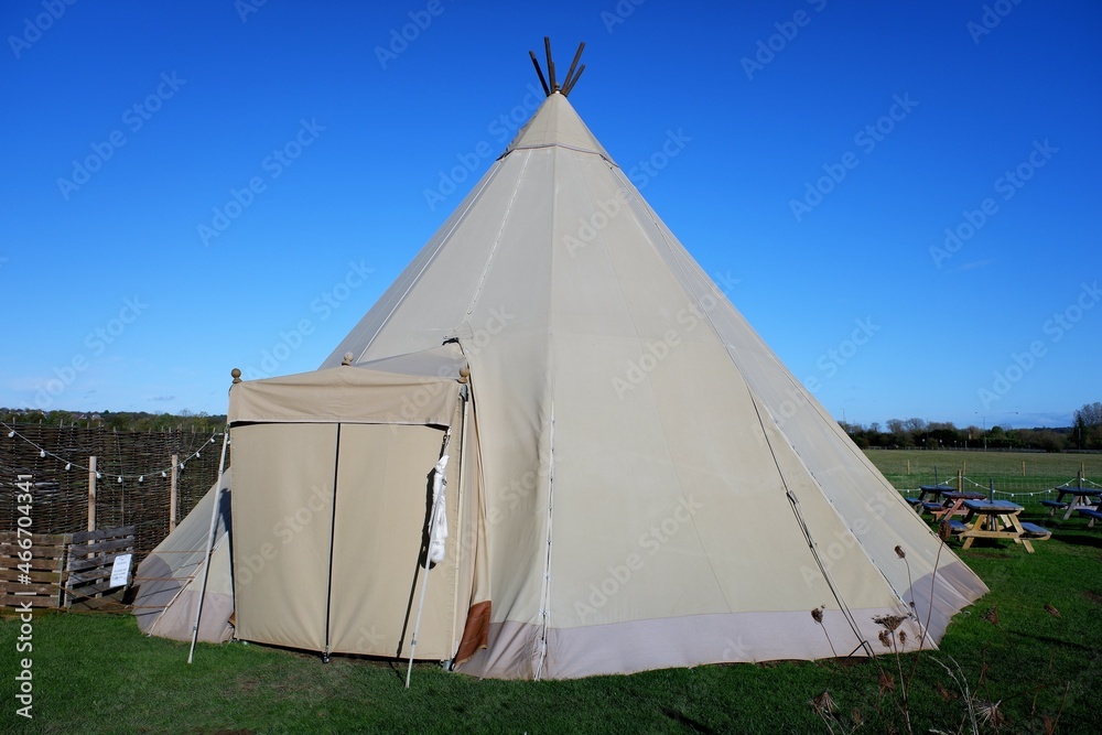 Large tipi with entrance awning on rural farmland