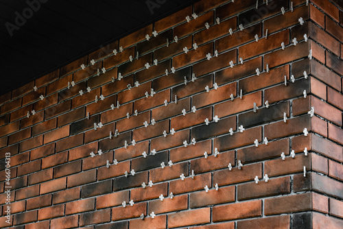 Installing the tiles in the form of brick on the wall using plastic crosses between the tiles.