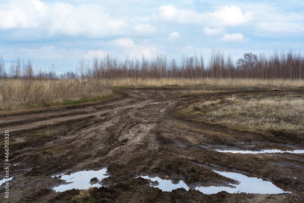 Bad country road. A dirt road damaged. Clay, dirt. Concept problem with the roads. human impact on the environment. Russian bad road Bad country road. A dirt road damaged. Clay, dirt. Concept problem with the roads. human impact on the environment. Russian bad road