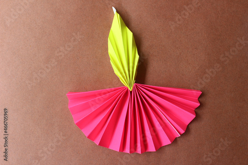 Diwali lamp made with origami paper on brown background