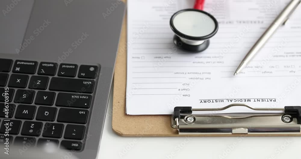 Medical history of patient with ballpoint pen and stethoscope lying on table near laptop 4k movie Medical history of patient with ballpoint pen and stethoscope lying on table near laptop 4k movie