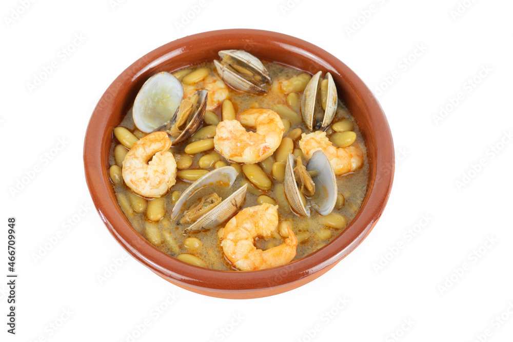 Fabas verdinas with prawns and clams in an earthenware casserole on a white background. Copy space. Fabas verdinas with prawns and clams in an earthenware casserole on a white background. Copy space.