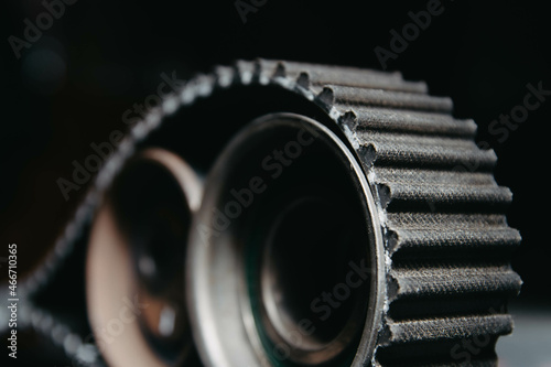 Obraz na płótnie automotive timing belt on a black background. Replacement concept for idler pulleys and engine belts. w salonie