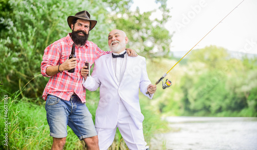retirement finally. hobby and sport activity. two fishermen with fishing rods. mature man fisher celebrate retirement. retired businessman. male friendship. family weekend. father and son fishing
