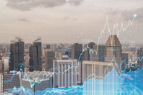 Market behavior graph hologram, sunset panoramic city view of Singapore, popular location to achieve financial degree in Southeast Asia. The concept of financial data analysis. Double exposure.