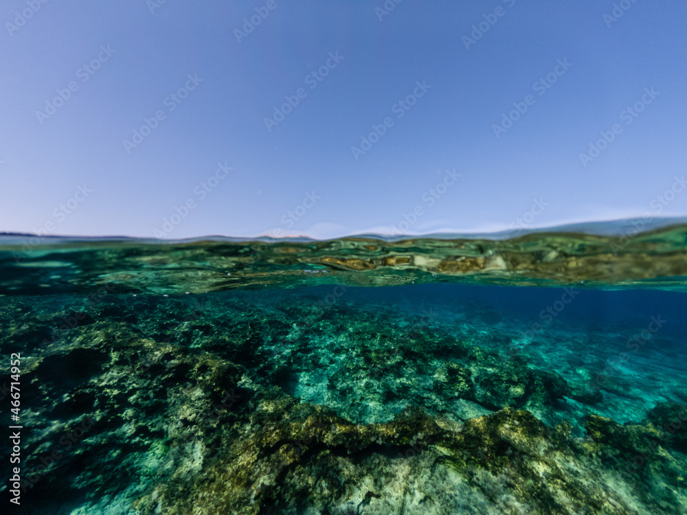 Half underwater of the clear azure sea