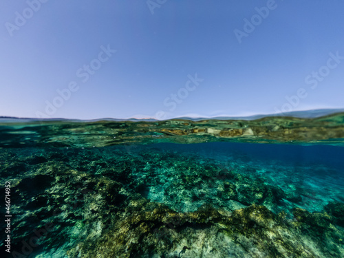 Half underwater of the clear azure sea