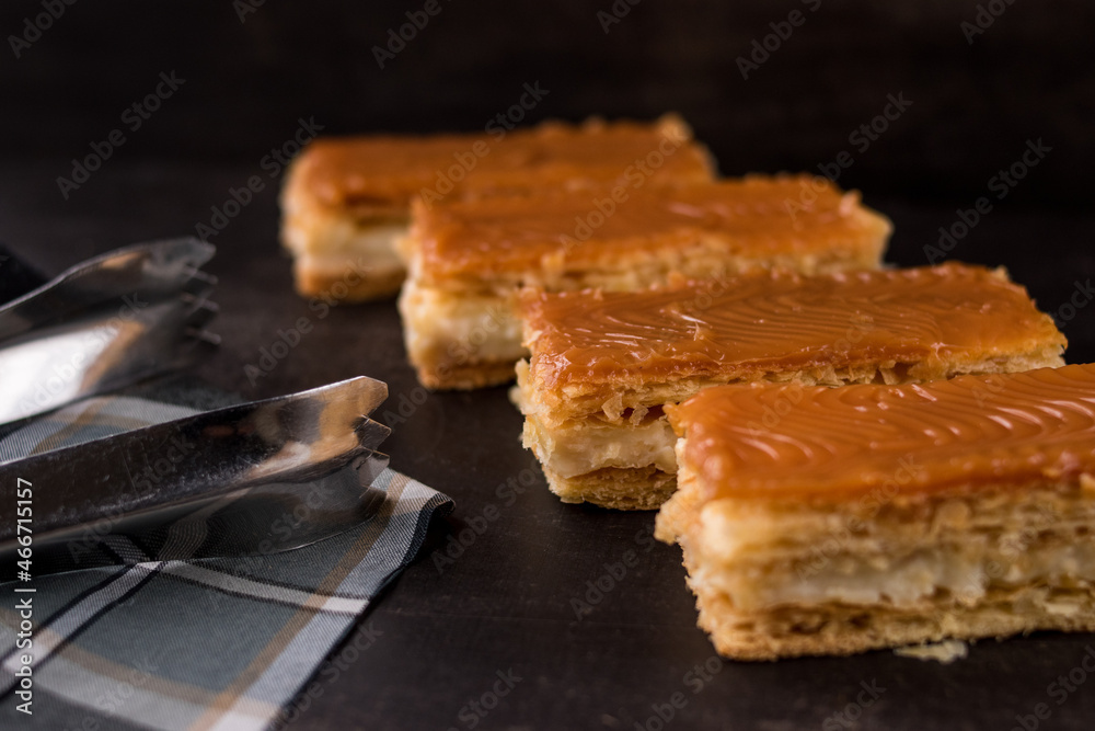 Traditional Colombian dessert Milhojas with tongs Stock Photo | Adobe Stock