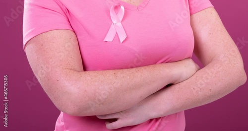 Wallpaper Mural Video of midsection of caucasian woman wearing pink cancer awareness ribbon, with pink background Torontodigital.ca