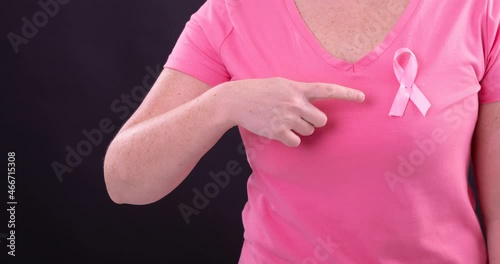 Wallpaper Mural Video of midsection of caucasian woman wearing pink cancer awareness ribbon, with black background Torontodigital.ca