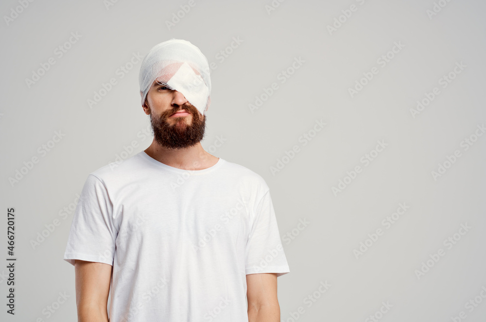 male patient with bandaged head and eye hospitalization isolated background