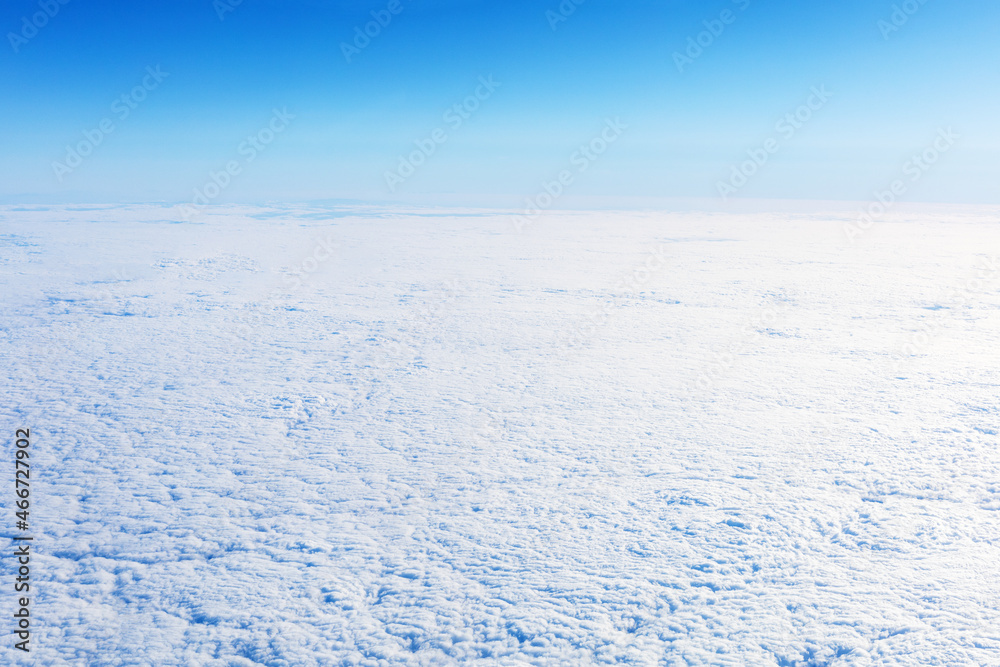 Arctic landscape. Snowy winter endless field with blue sky.