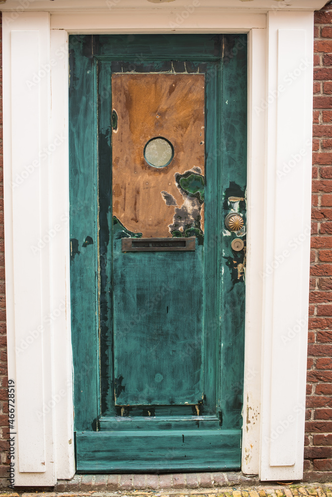 old turquoise wooden door in the town