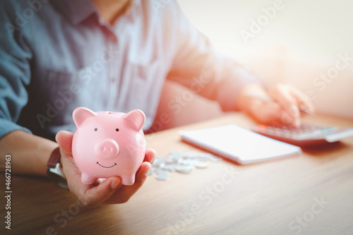 Pink piggy bank on hand for account save money. Planning step up, saving money for future plan, retirement fund. Business investment-finance accounting concept.