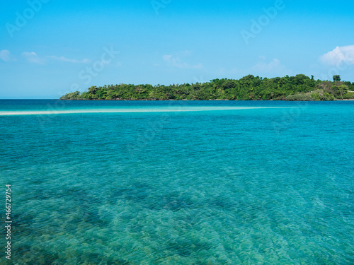 Breathtaking view of Koh Kham Island sand bar and crystal clear turquoise water with coral reef against clear blue sky. Near Koh Mak, Trat, Thailand.