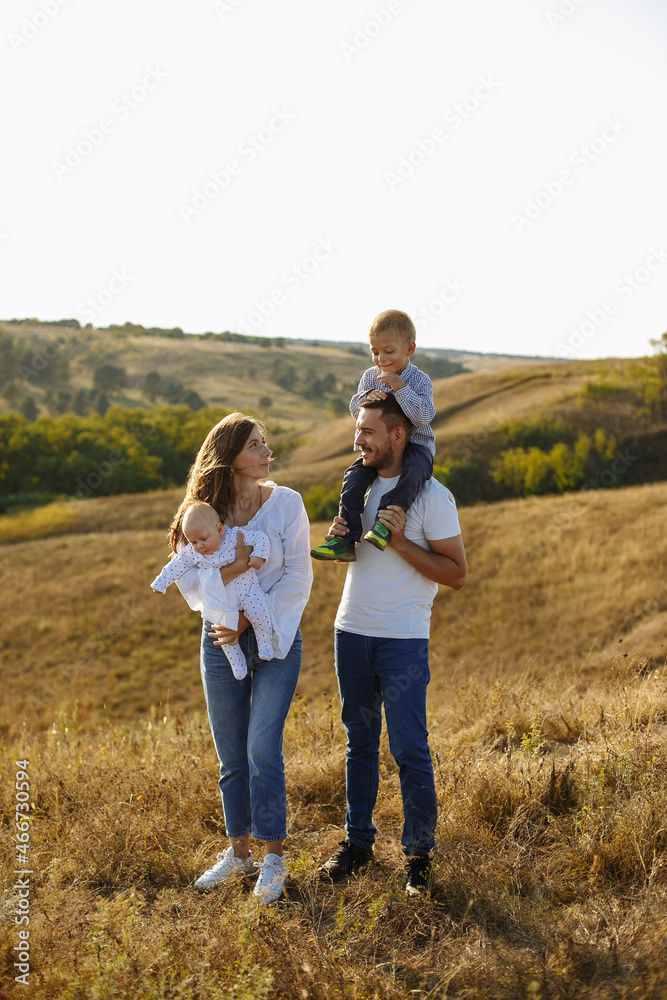family in white t-shirts and blue jeans walking in nature