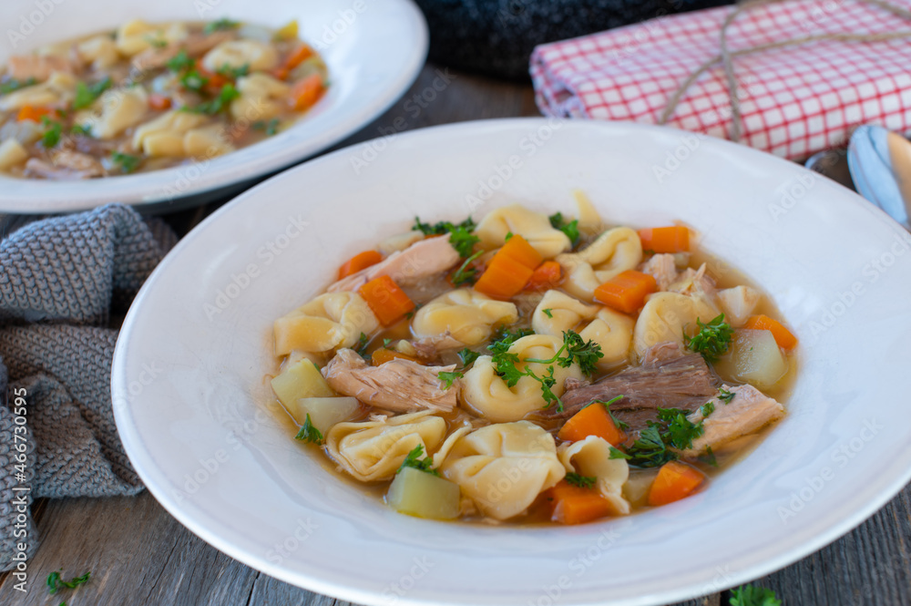 Rustic chicken noodle soup cooked with tortellini Rustic chicken noodle soup cooked with tortellini