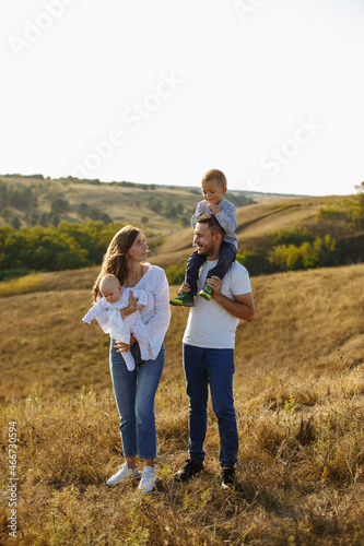 family in white t-shirts and blue jeans walking in nature