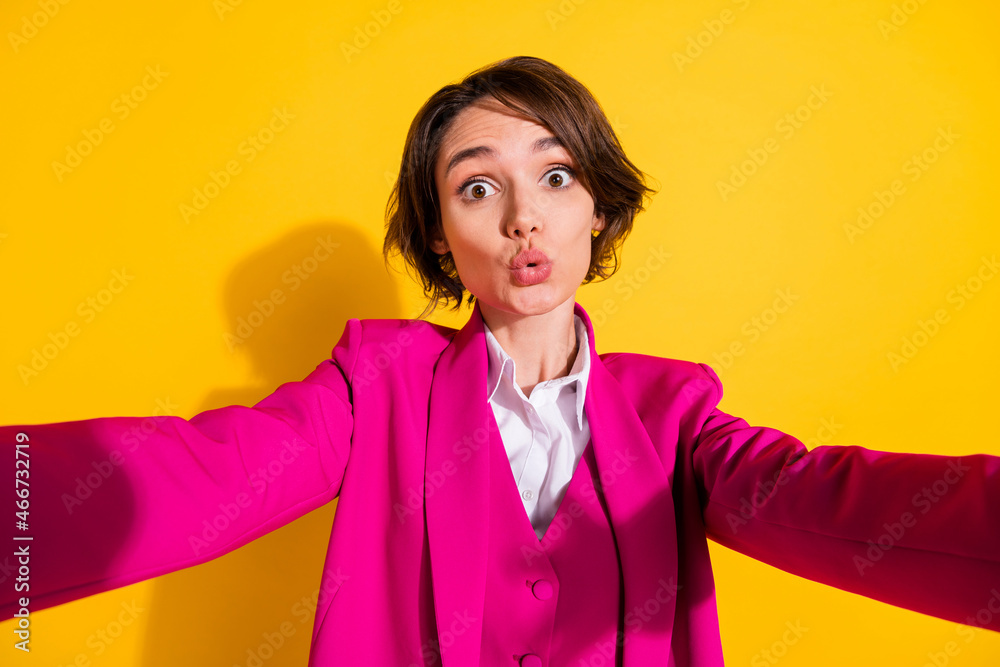 Photo of pretty impressed young woman dressed pink suit recording self video isolated yellow color background Photo of pretty impressed young woman dressed pink suit recording self video isolated yellow color background