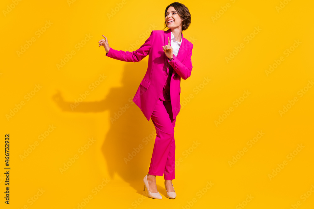 Photo of charming funky young woman dressed pink suit dancing smiling isolated yellow color background Photo of charming funky young woman dressed pink suit dancing smiling isolated yellow color background