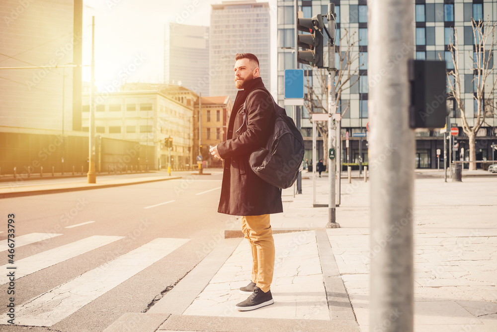 Young bearded caucasian elegant man outdoor stopping at traffic light strolling city
