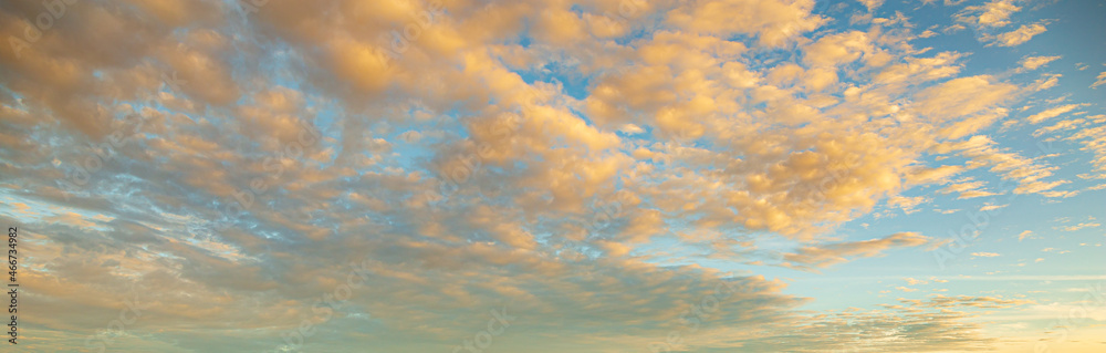 Clouds and evening sky,Real majestic sunrise sundown sky background with gentle colorful clouds without birds. Panoramic, big size