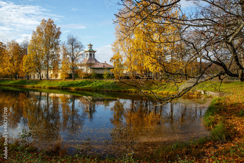 Beautiful autumn park with lake and colorful leaves.