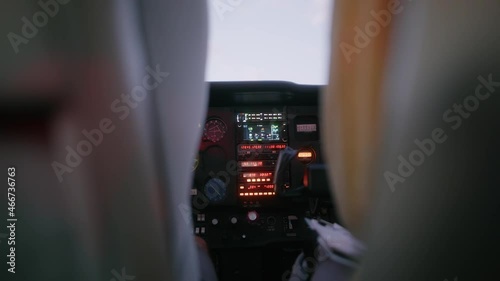 Man flying a small Cessna plane during the sunrise.
