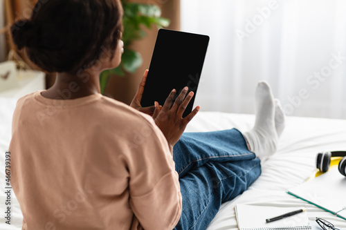 Black Woman Using Digital Tablet With Empty Screen Indoor, Rear-View