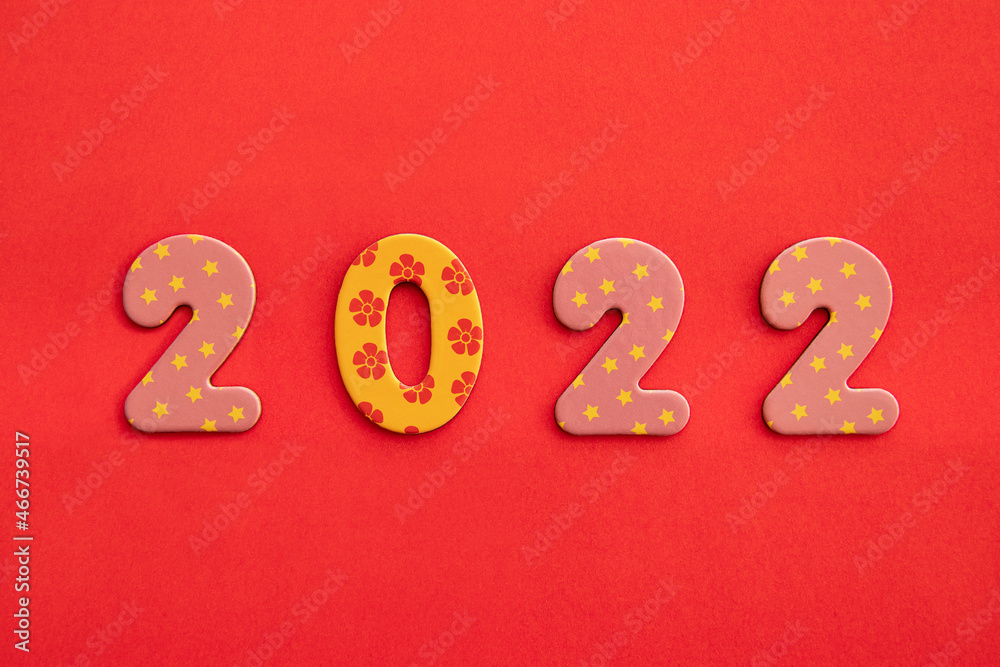 Decorative numbers 2022 new year on red background with copy space Decorative numbers 2022 new year on red background with copy space