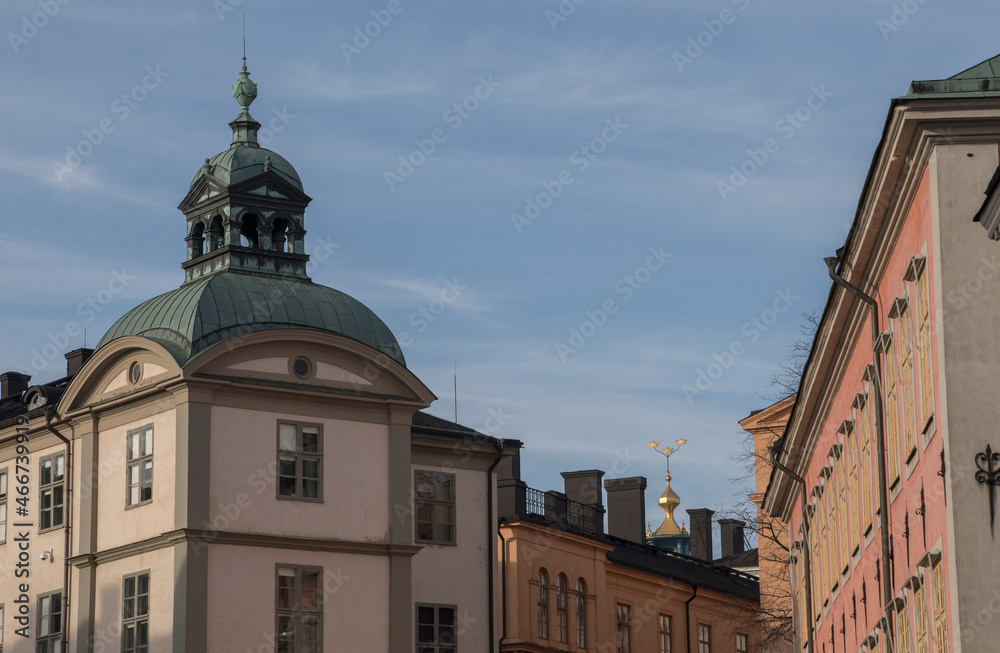 Collage with different kind and shapes of roofs and facades on the island Riddarholmen a part of the old town Gamla Stan in Stockholm and a the three crowns on the tower of the Town City Hall