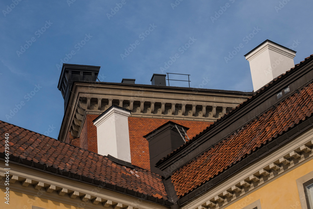 Tile and tin roofs with chimneys on tile and plastered old houses in the island Riddarholmen a part of the old town Gamla Stan in Stockholm