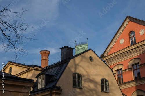 A tower and facades and roofs of houses on the island Riddarholmen a part of the old town in Stockholm