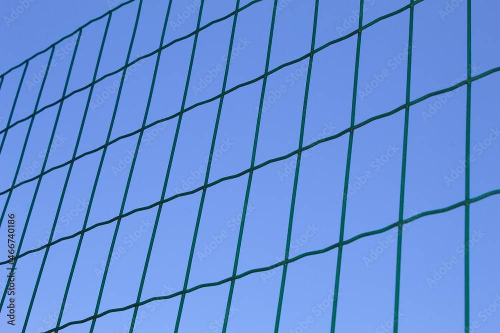 Rectangular fence with metal and blue sky background. Rectangular fence with metal and blue sky background.